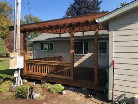 Wood deck with a timber patio cover and railing